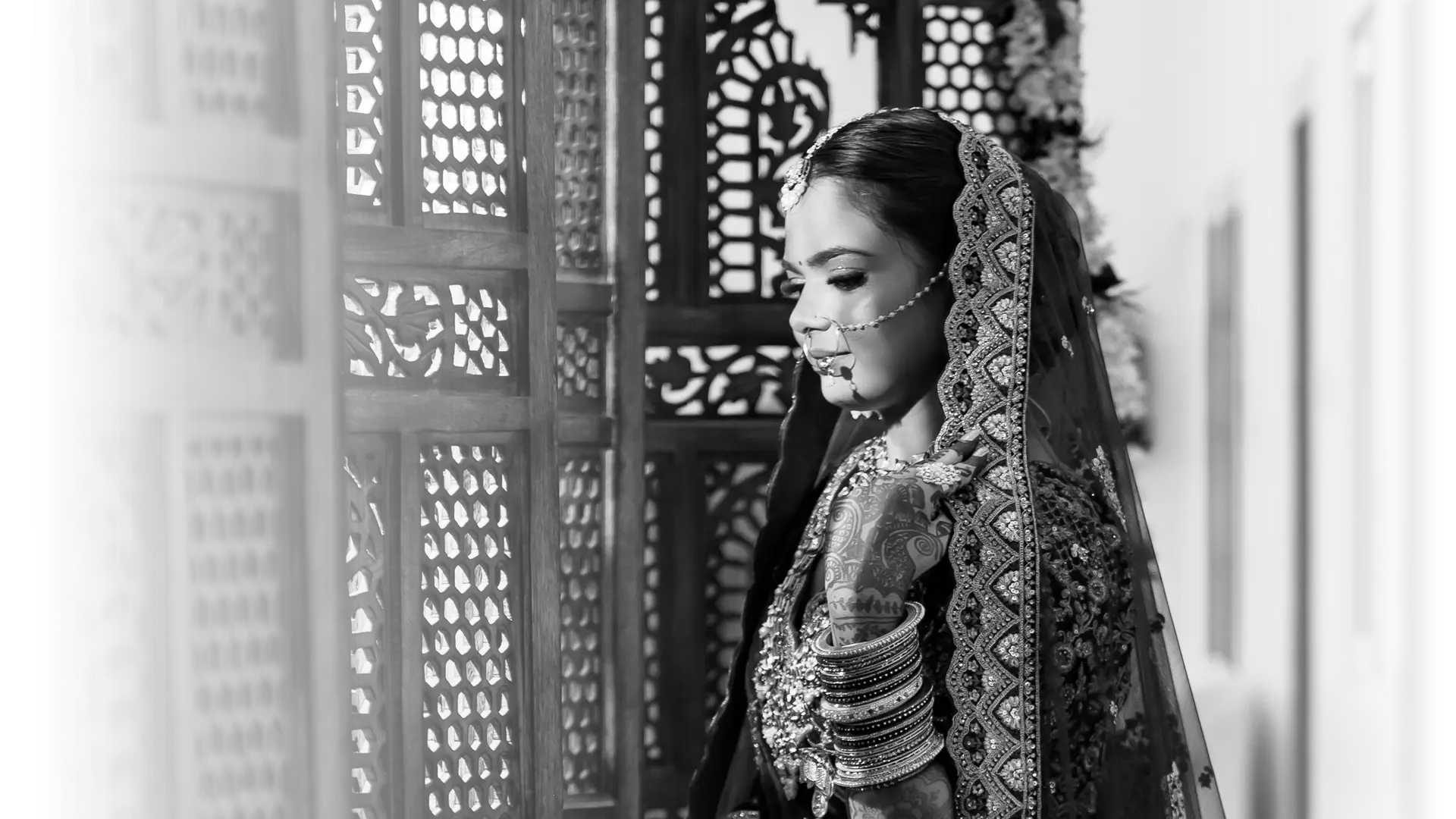 Bride in traditional attire, elegant pose.